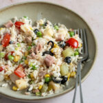 Italian rice salad with tuna, tomatoes, ham, olives and many other mix-ins in a dish