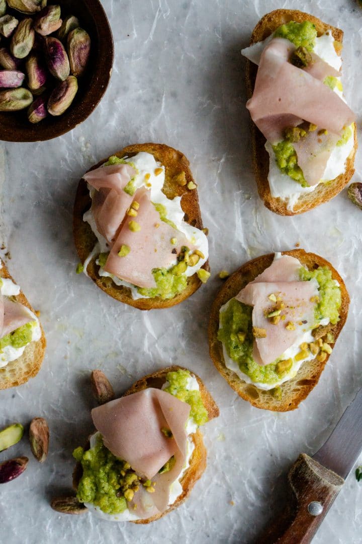 Burrata Crostini with Mortadella and Pistachio Pesto Pina Bresciani