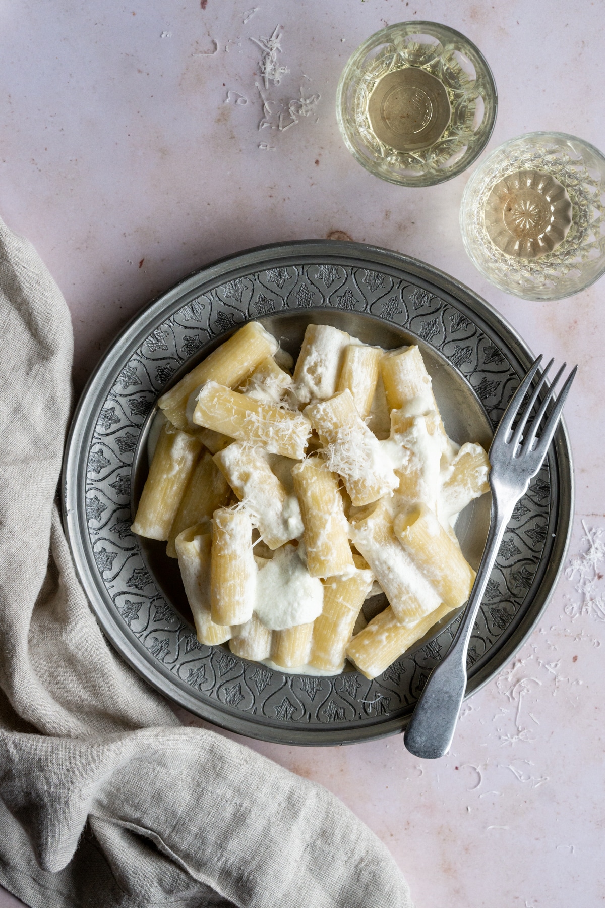 Ricotta pasta in a plate with a fork and napkin to the side