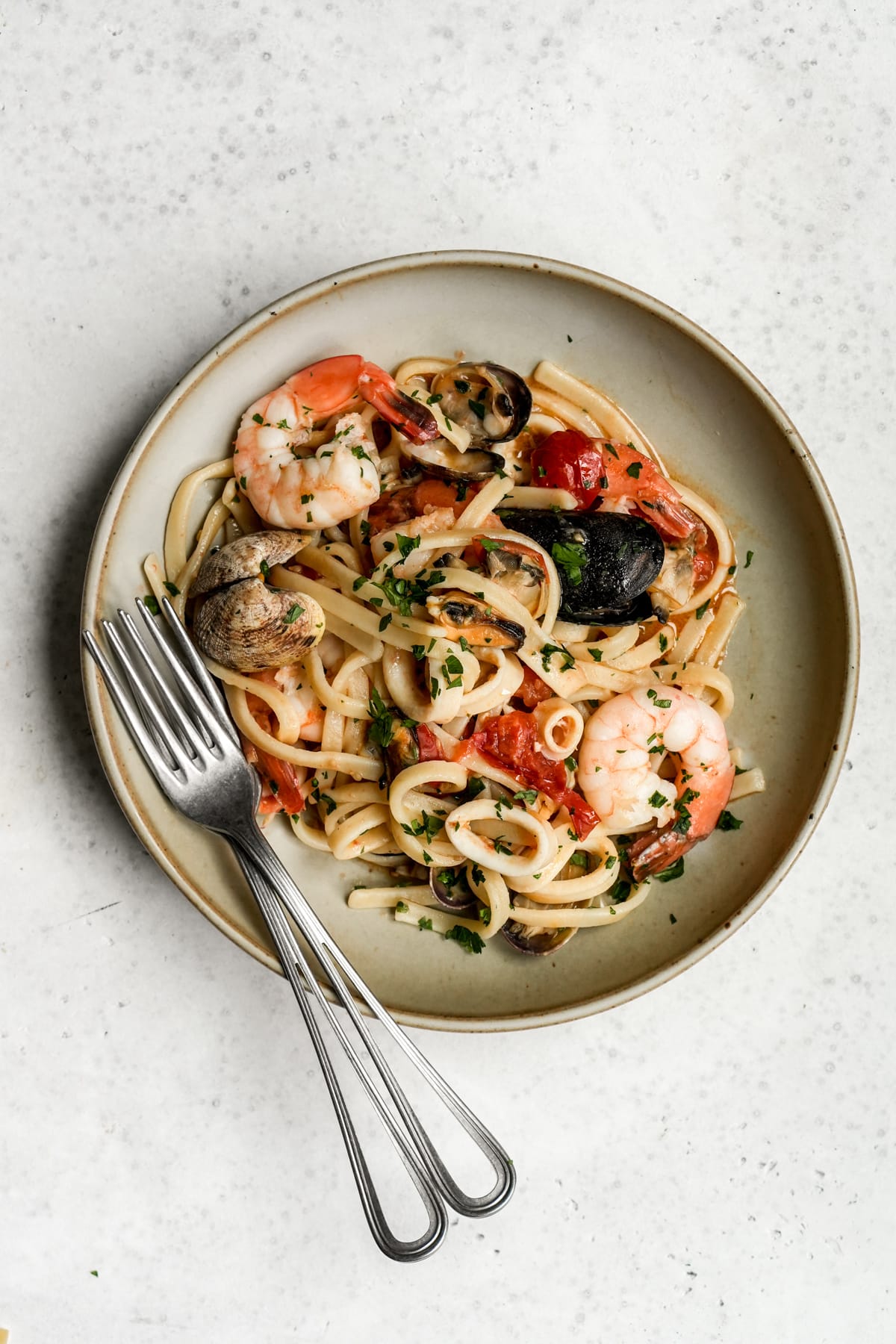Italian seafood pasta in a dish with forks to the side