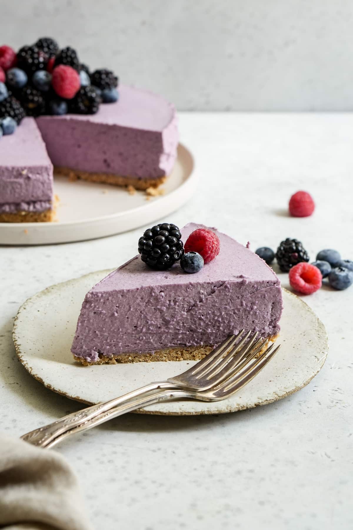 Slice of berry mousse cake on a plate