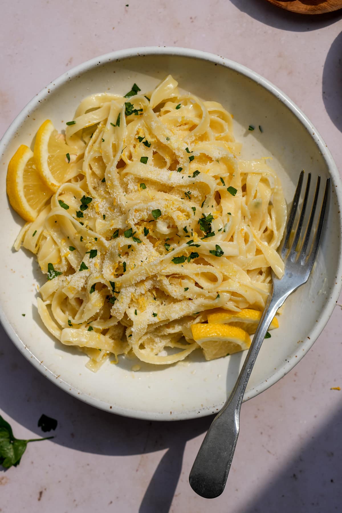 Creamy lemon pasta in a plate topped with parsley