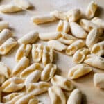 Cavatelli pasta on a wooden board dusted with flour