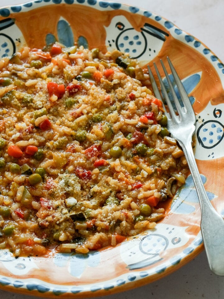 Vegetable risotto in a plate with a fork to the side