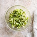 Puntarelle salad iin a glass bowl with a napkin to the side
