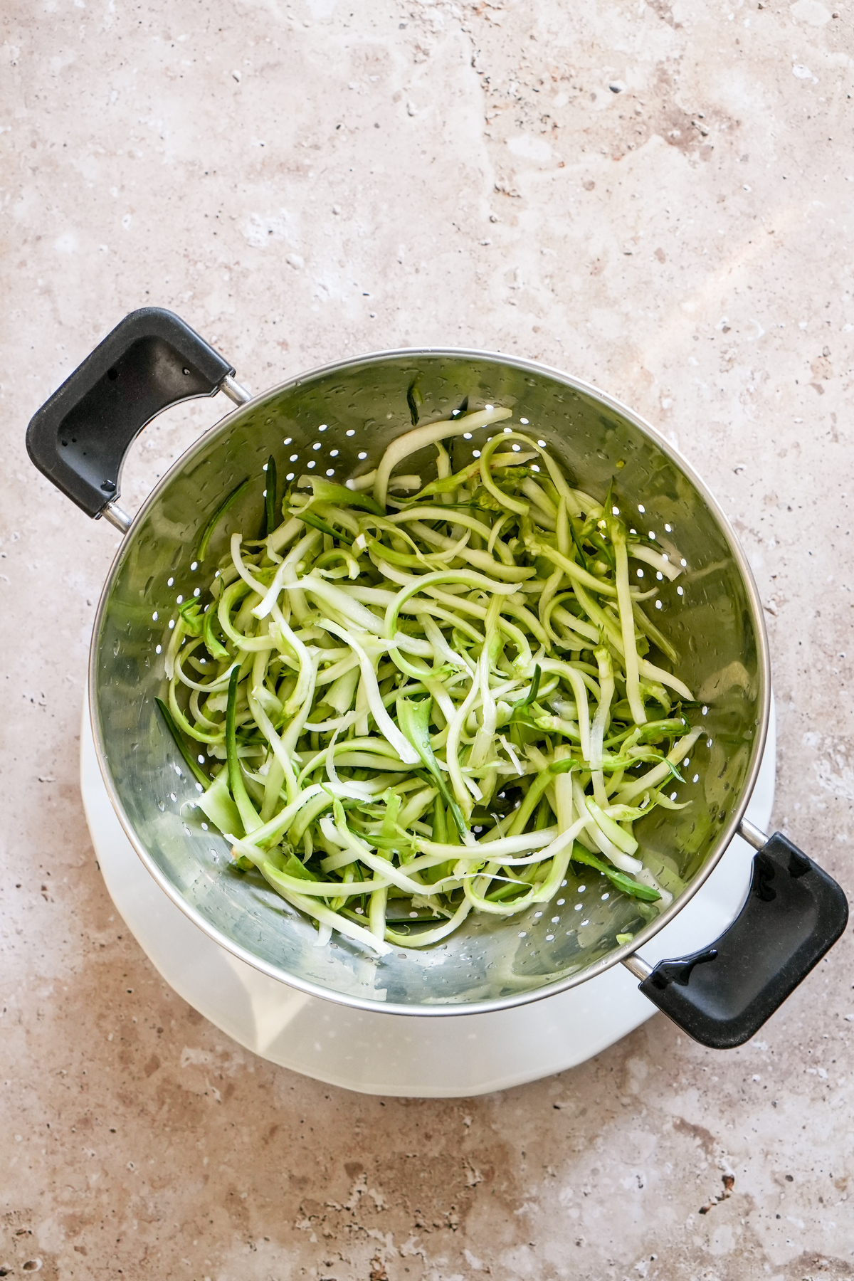 Julienned puntarelle drying in a colander
