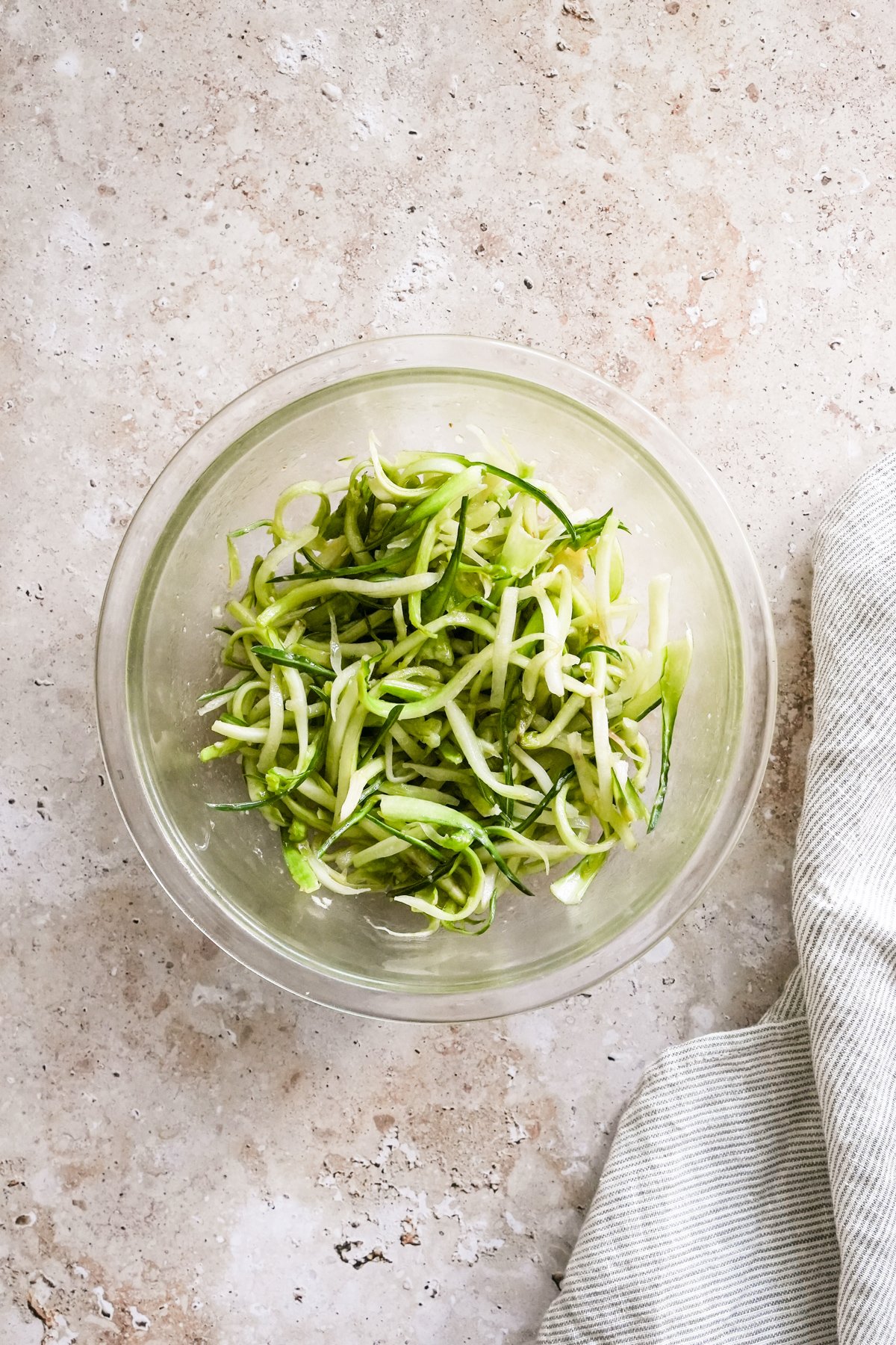 Puntarelle salad in a glass bowl with a napkin to the side