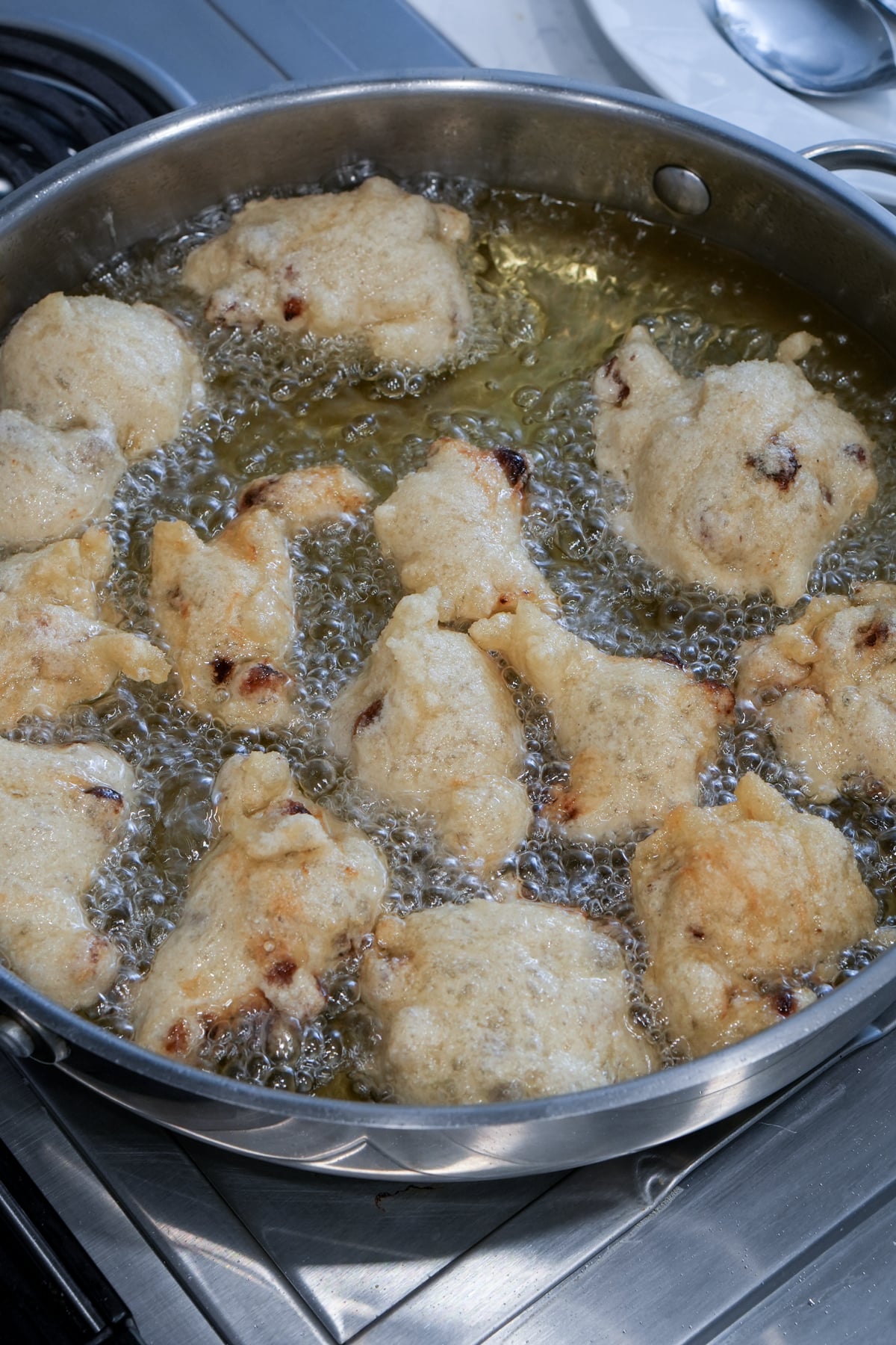 Zeppole being fried in oil
