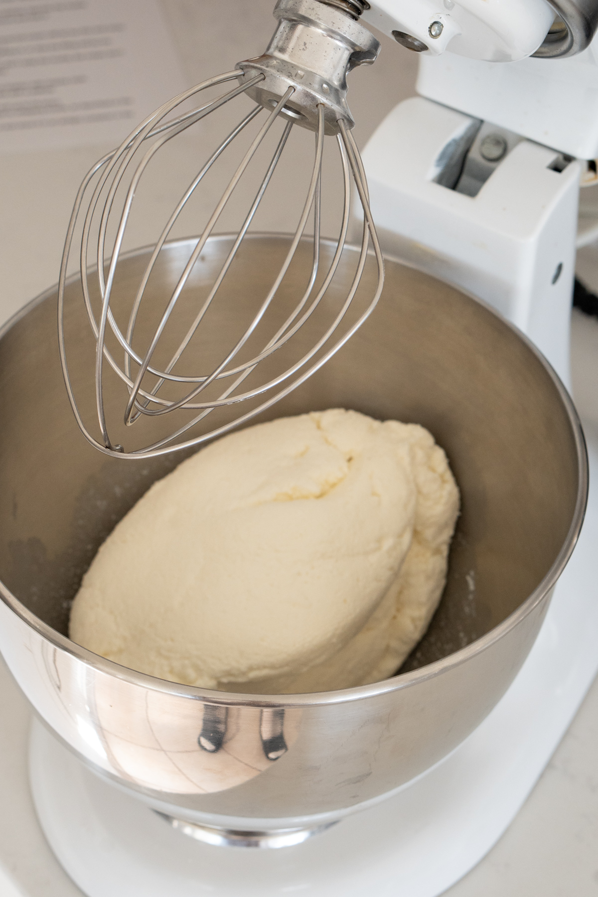 drained ricotta cheese in the bowl of a stand mixer