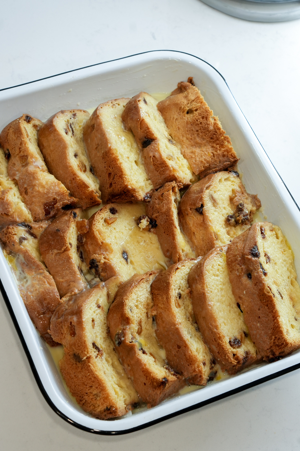 Panettone slices in a baking dish covered in custard