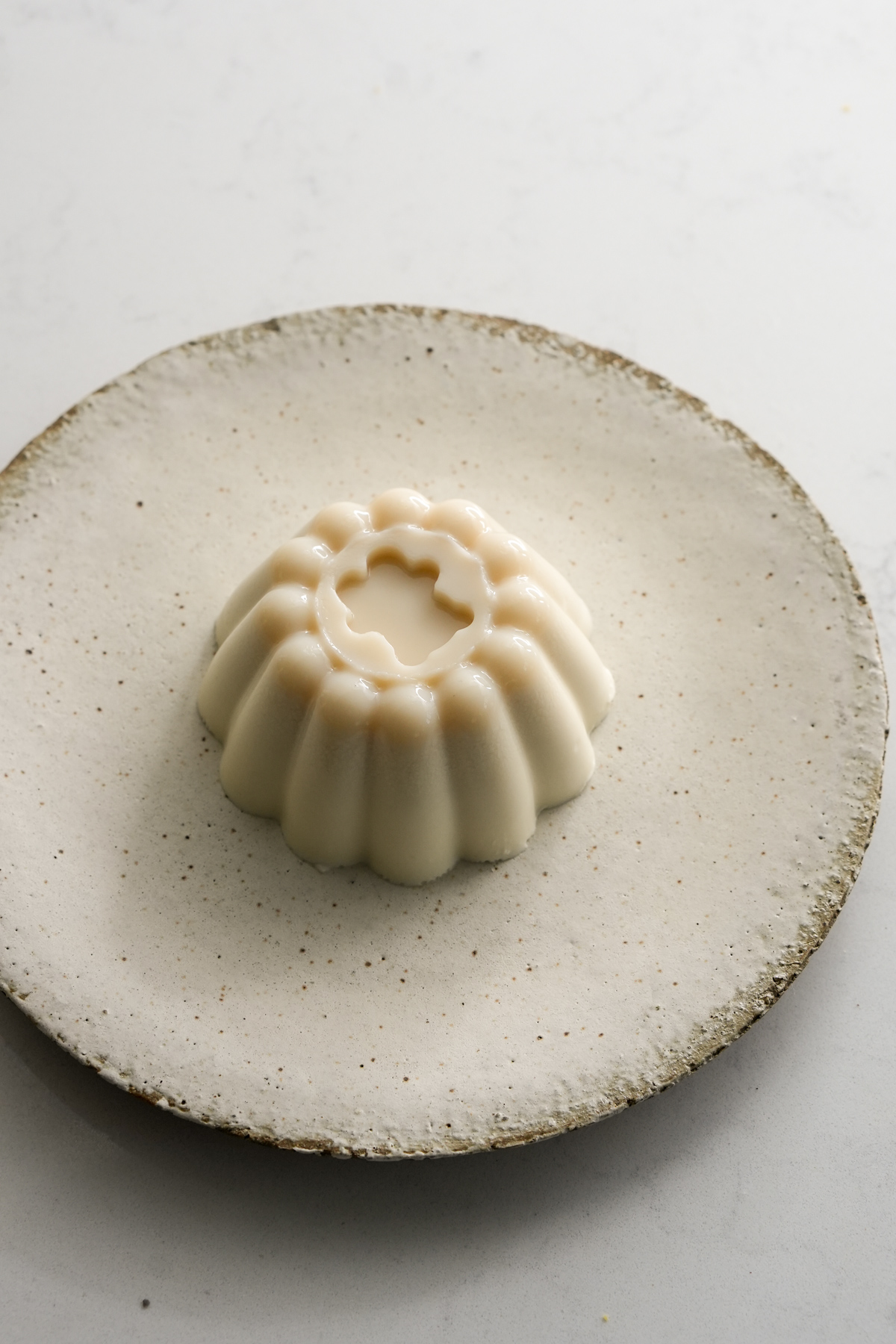 Unmolded panna cotta serving in a dish