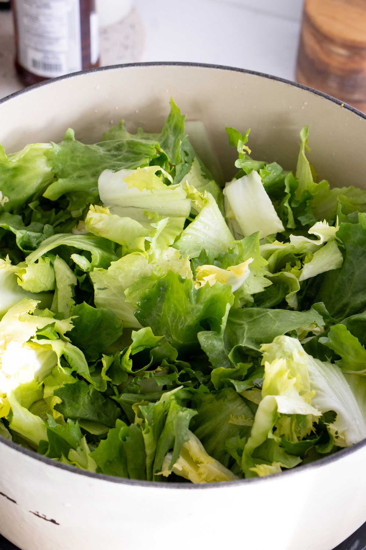Raw cut-up escarole in a pot