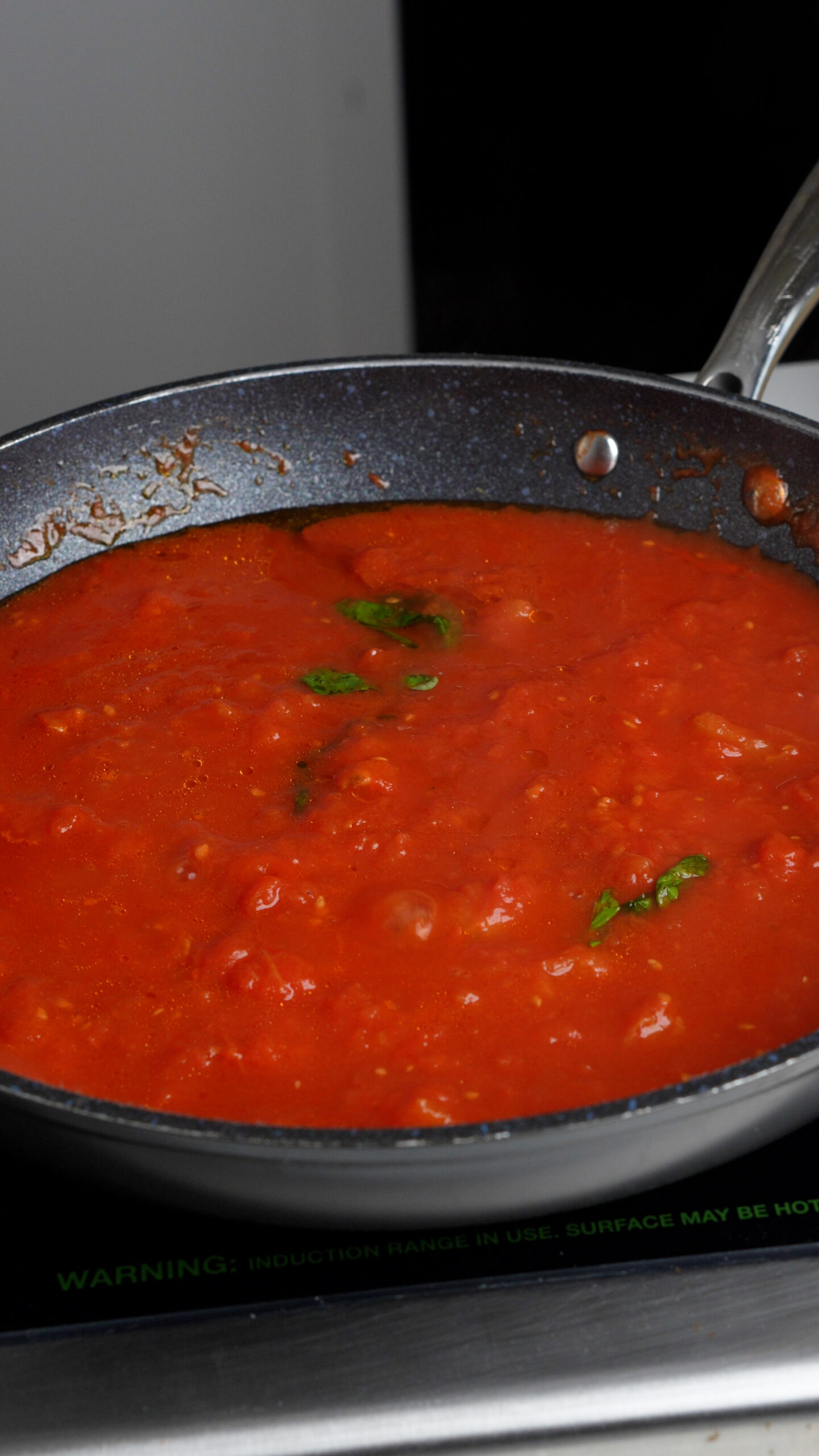 Tomato sauce in a pan with basil