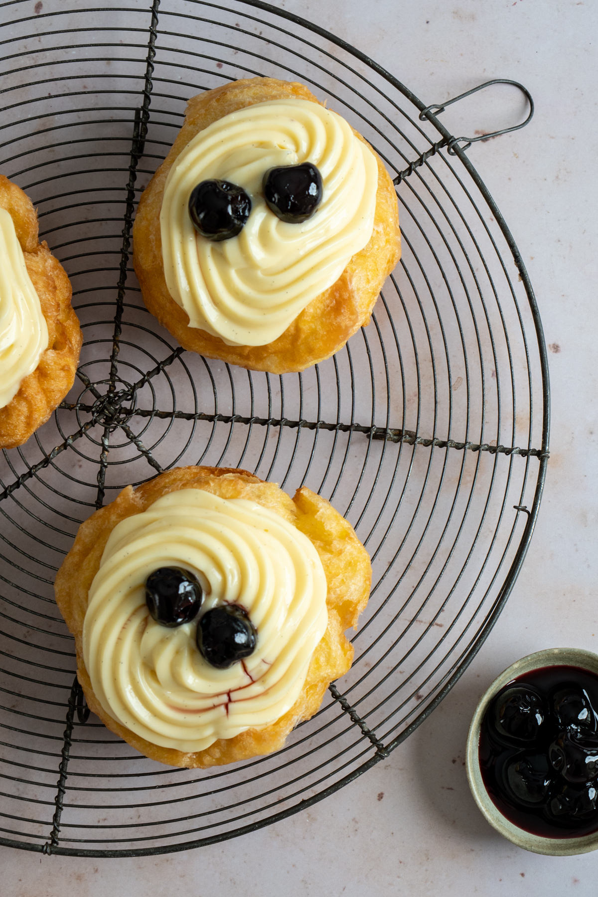 Zeppole di San Giuseppe on a round cooling rack
