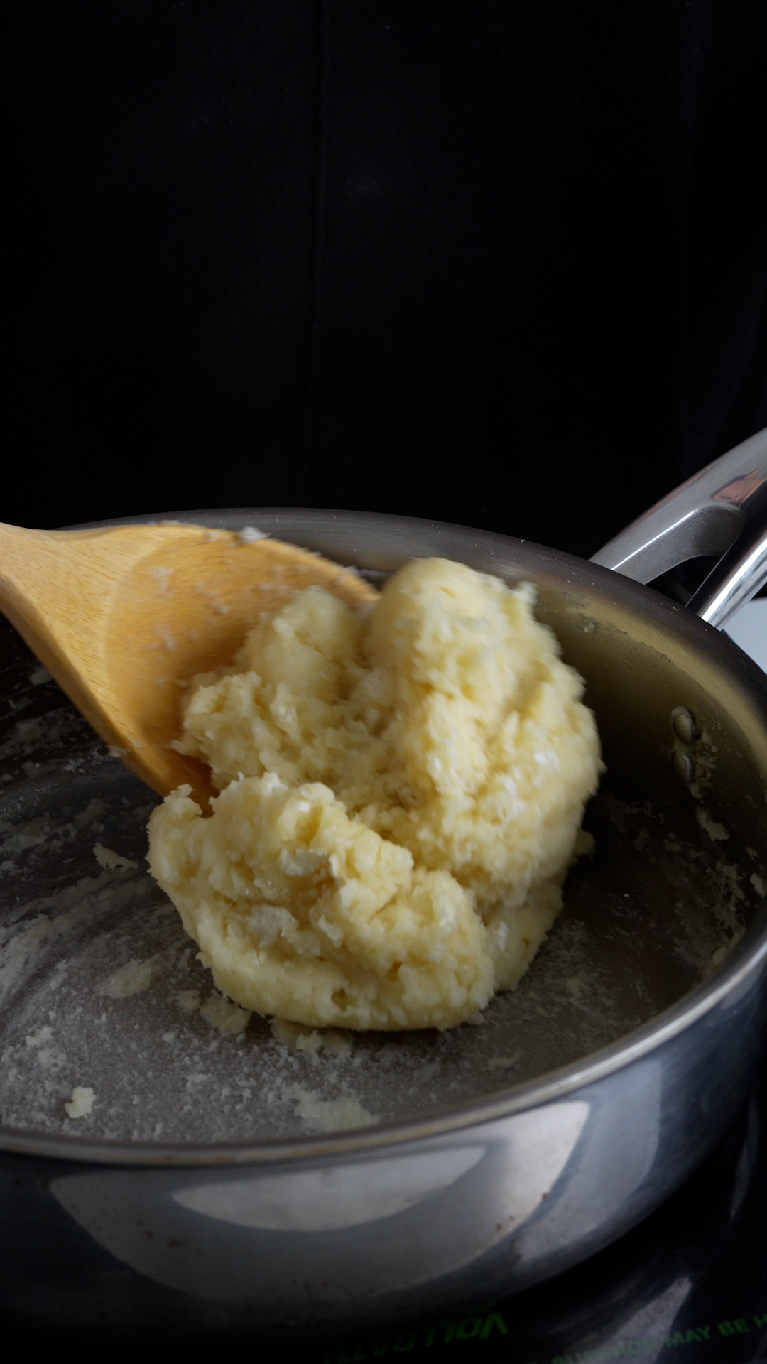 Ball of zeppole dough coming together in a pan