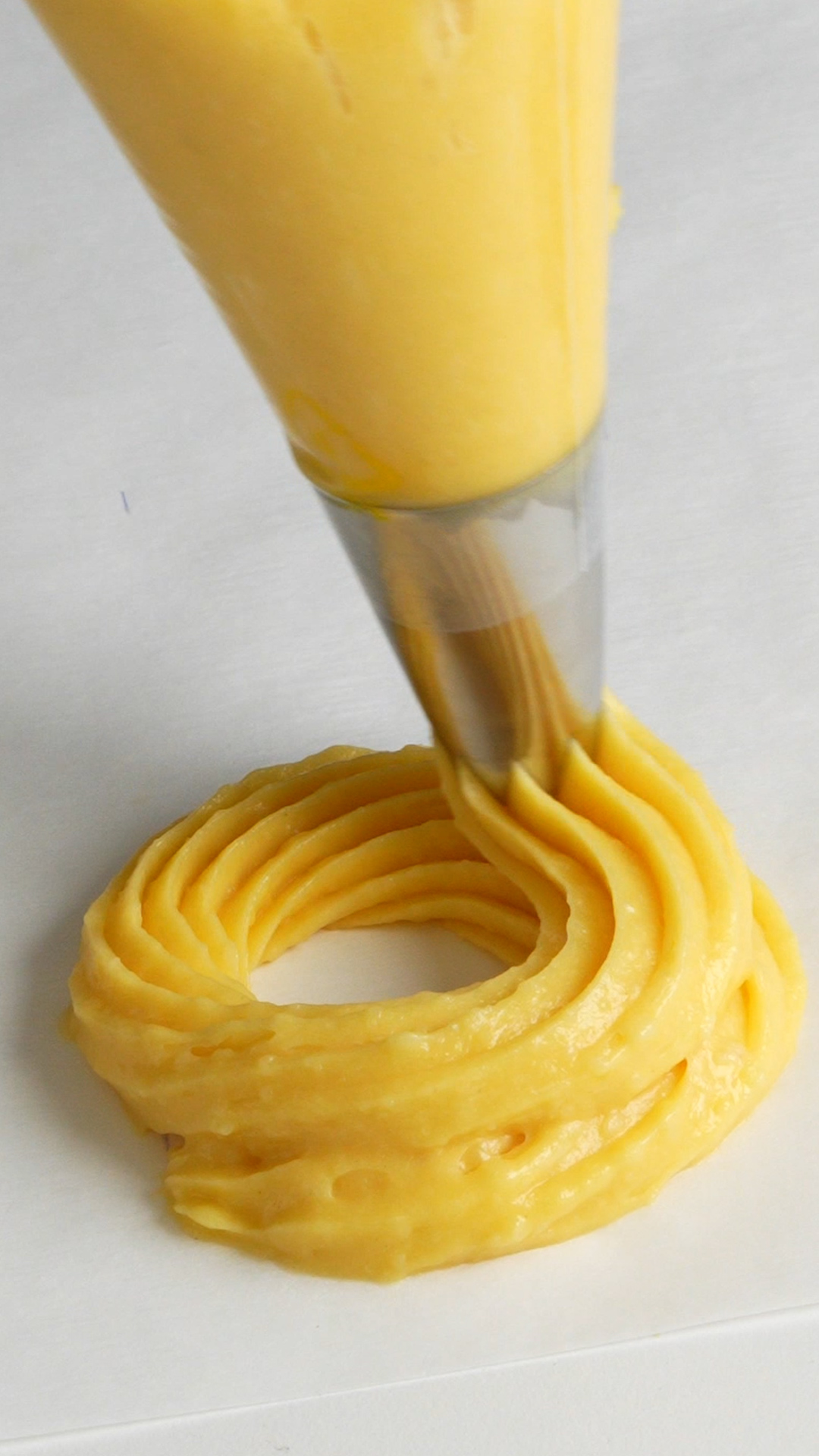 Zeppola being piped onto parchment paper