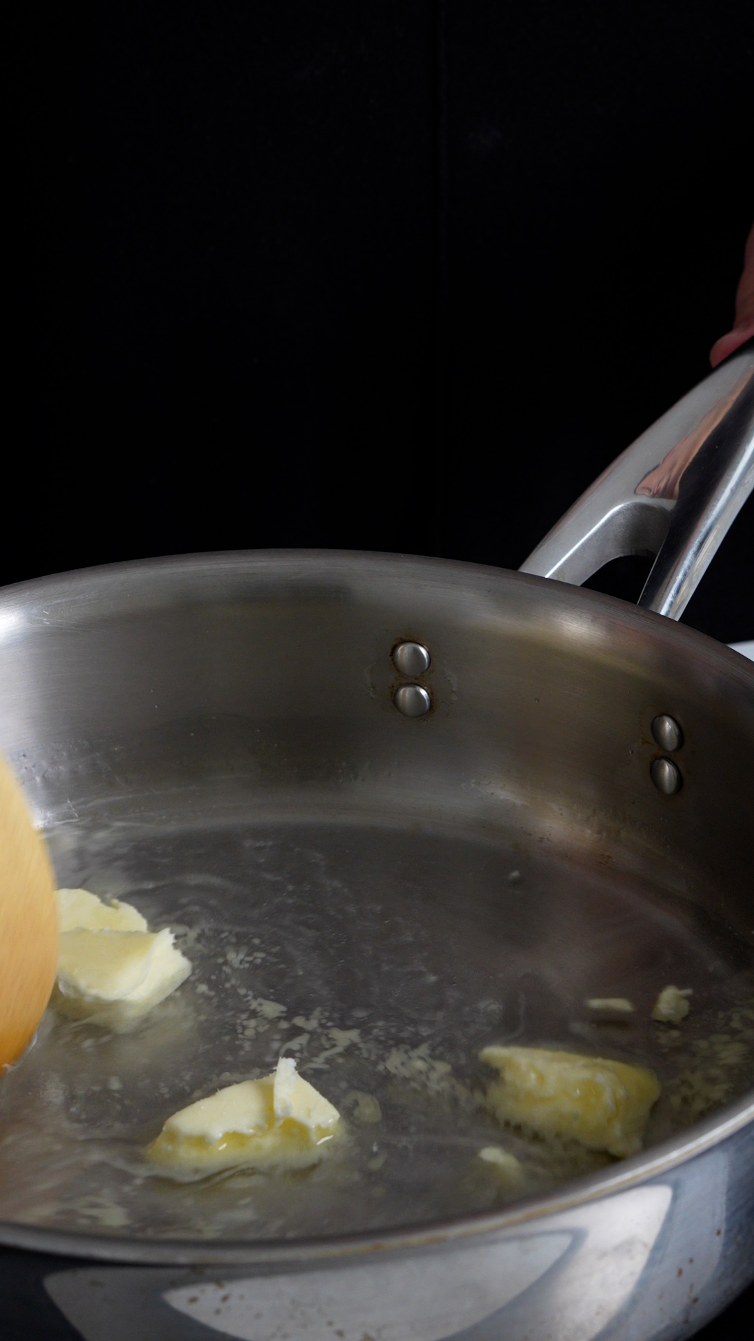 Butter and water being melted in a pan