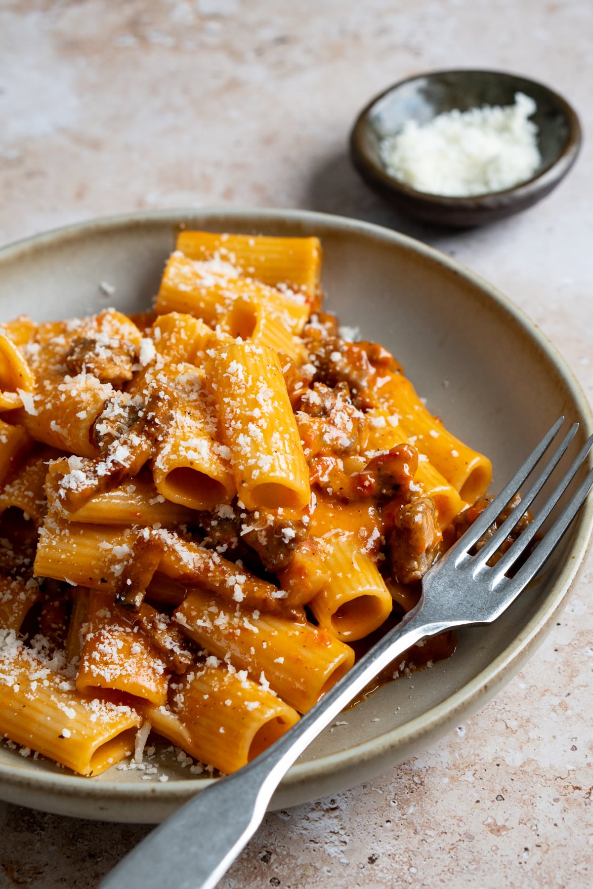 Pasta alla zozzona in a dish topped with grated pecorino romano