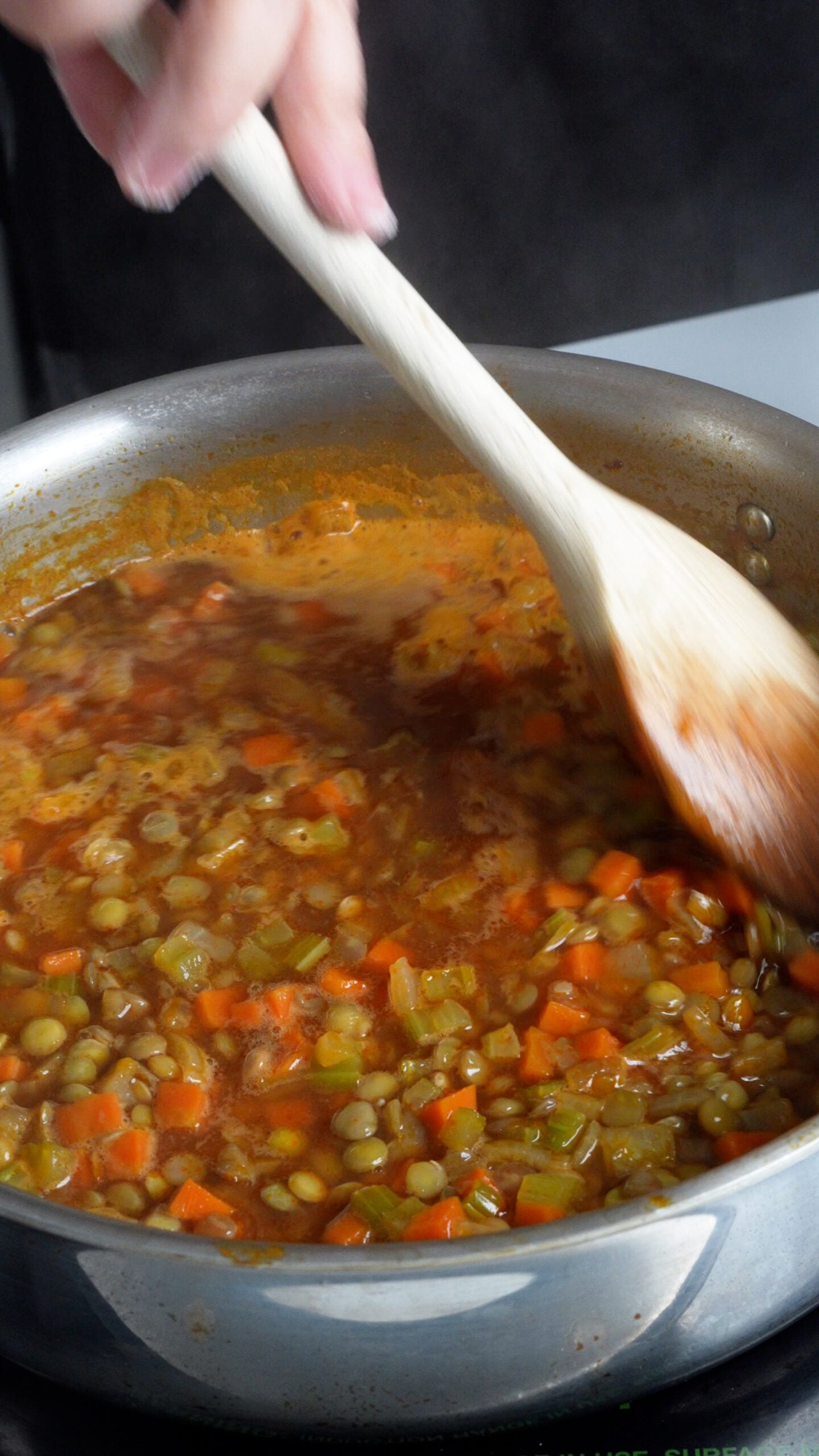 Small diced cooked carrot, celery and onion in a pan with lentils and broth