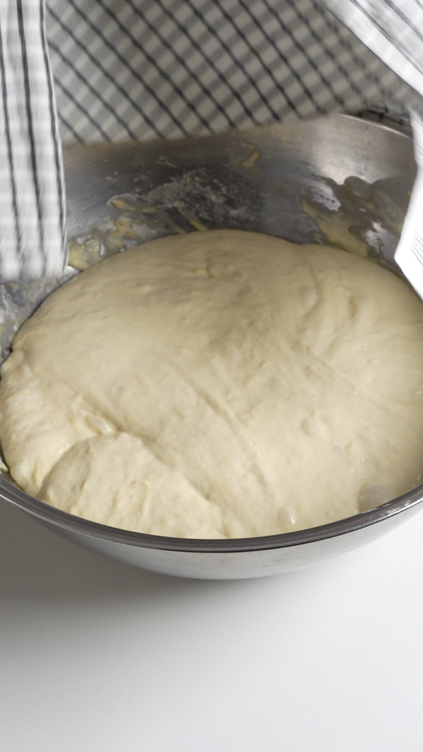 Risen focaccia dough in a bowl