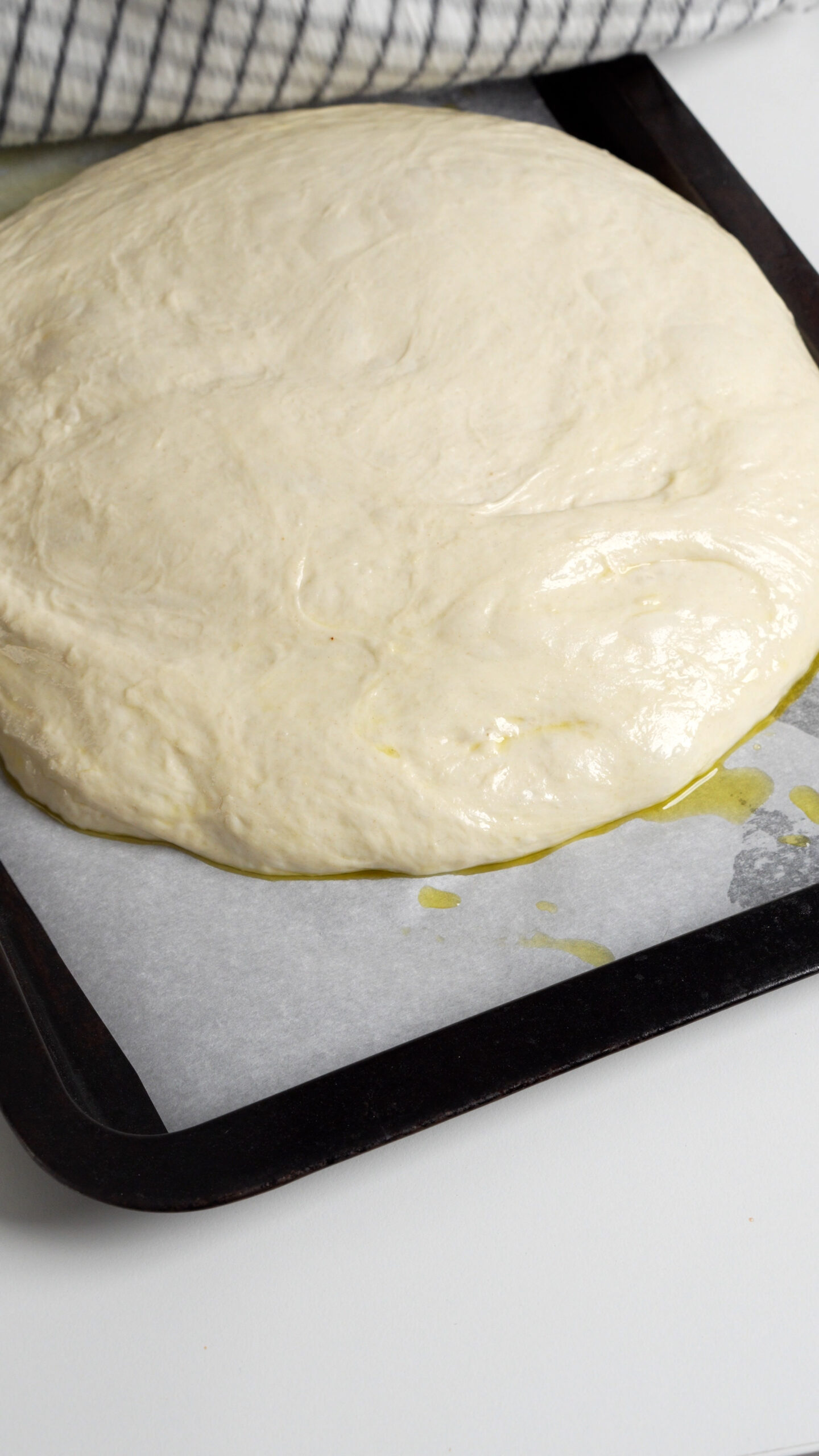 Focaccia dough on a baking sheet