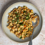 Dish of pasta and lentils topped with minced parsley