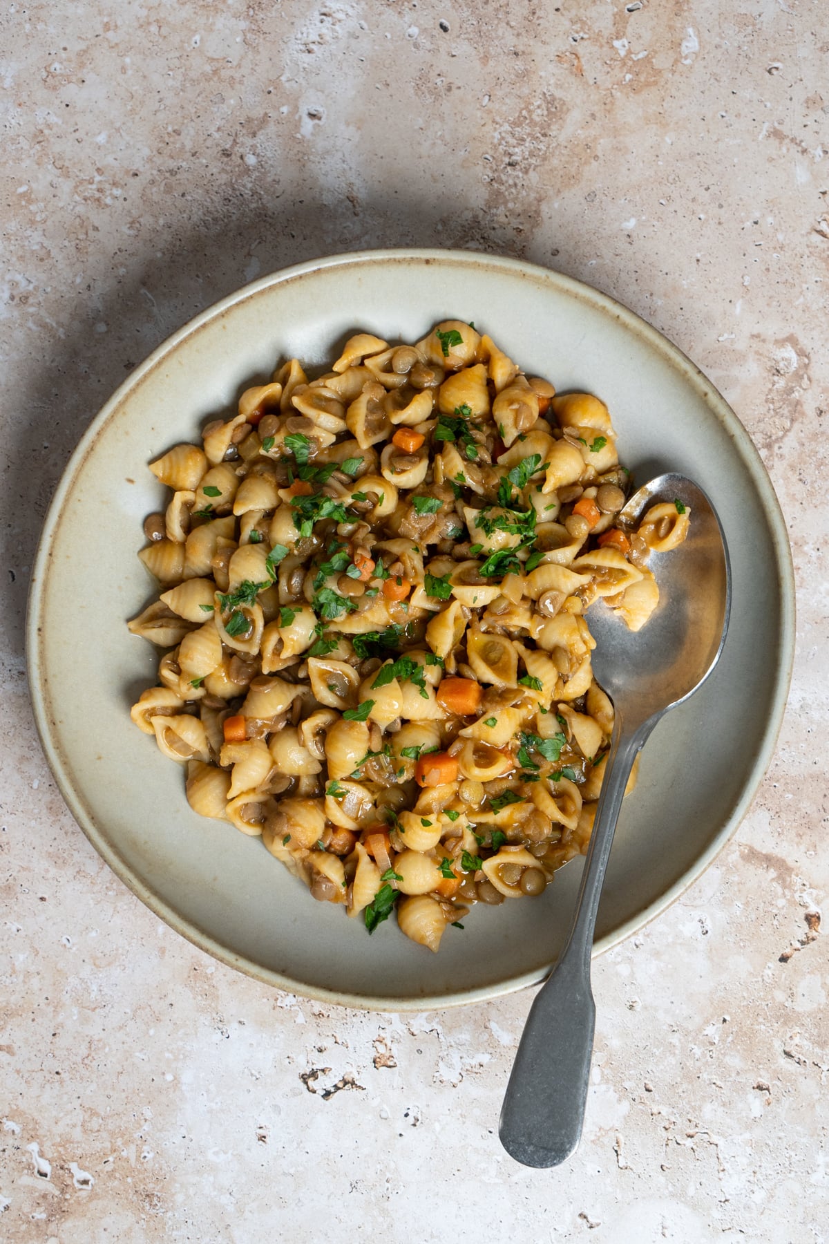 pasta and lentils in a dish with a spoon