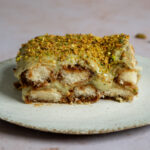 One piece of pistachio tiramisu on a plate