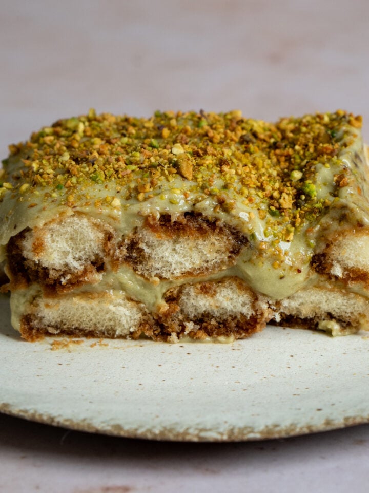 One piece of pistachio tiramisu on a plate