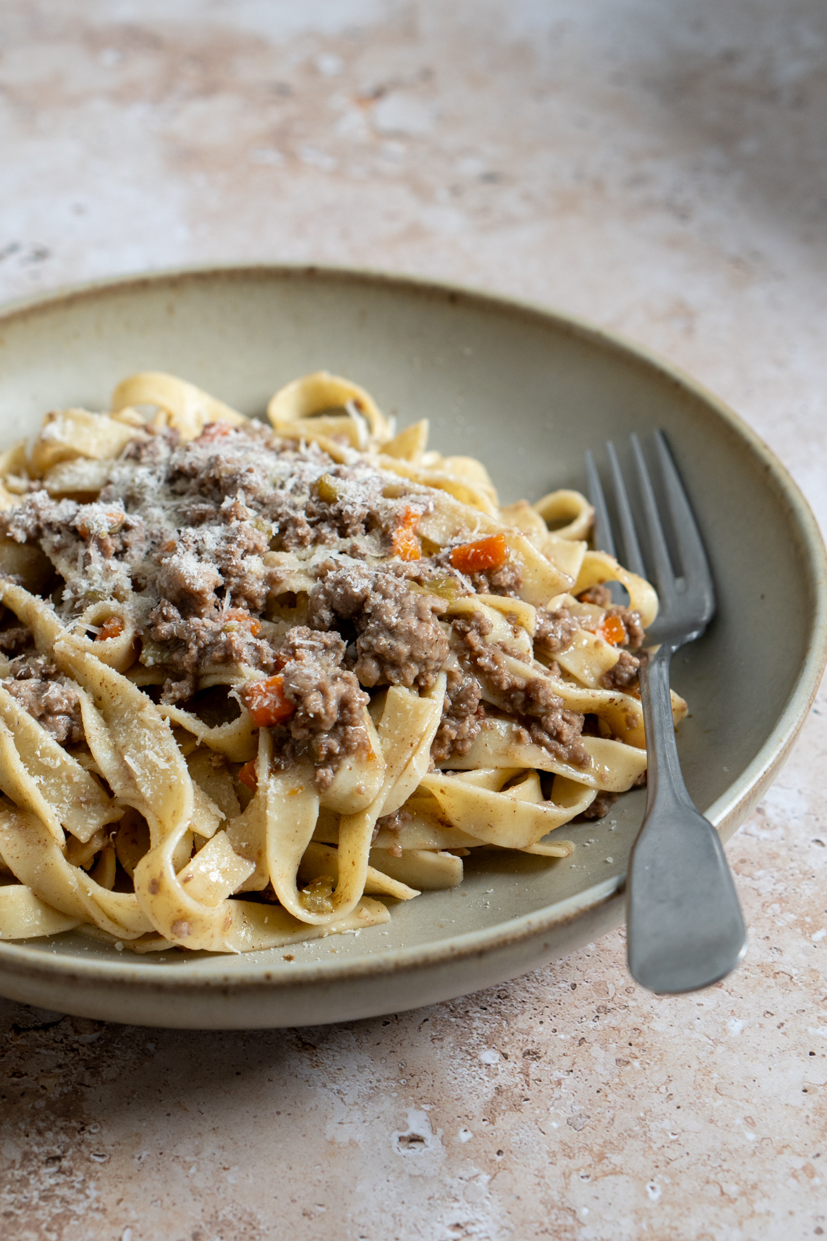 Tagliatelle with ragu bianco in a dish with a fork to the side