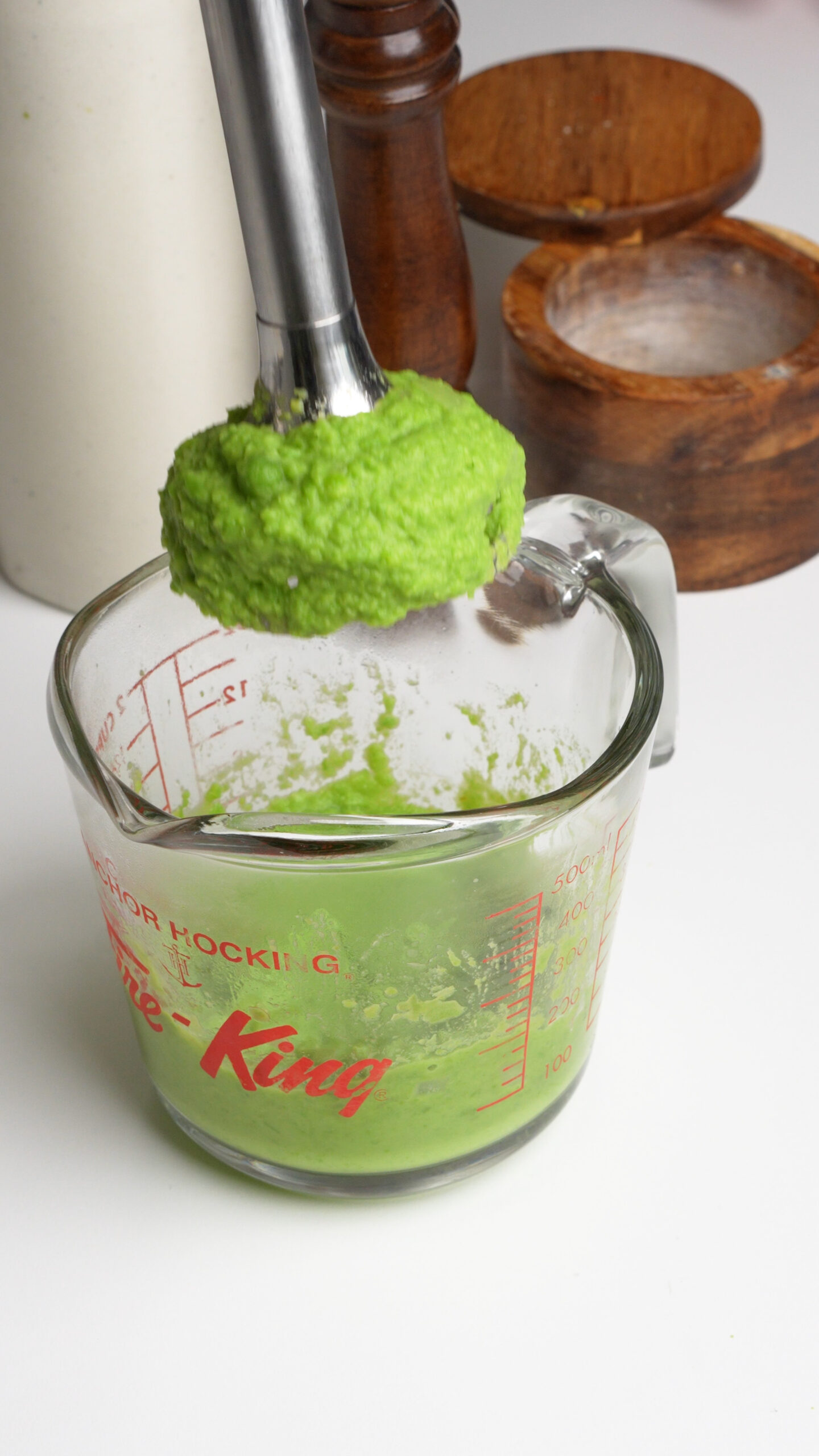Pea purée being blended with an immersion blender