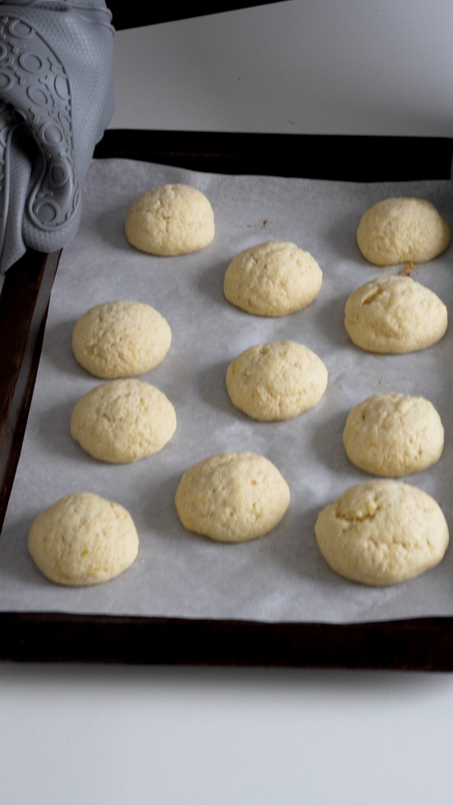 Baked lemon ricotta cookies on a baking sheet