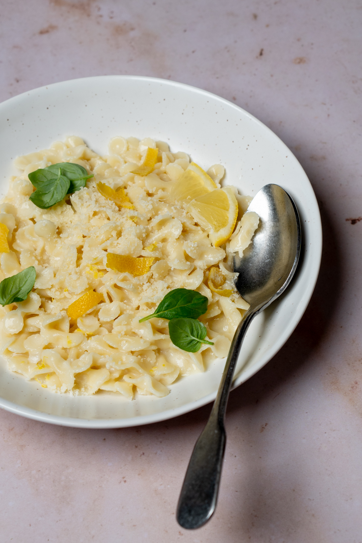 Pasta al limone in a plate with a spoon to the side