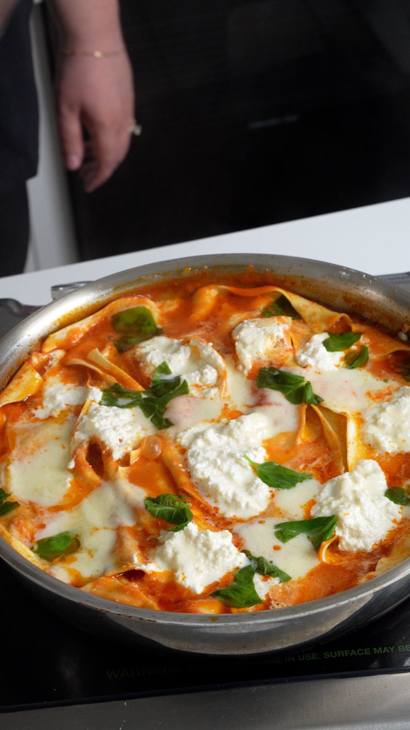 One pot lasagna in a pan topped with fresh basil