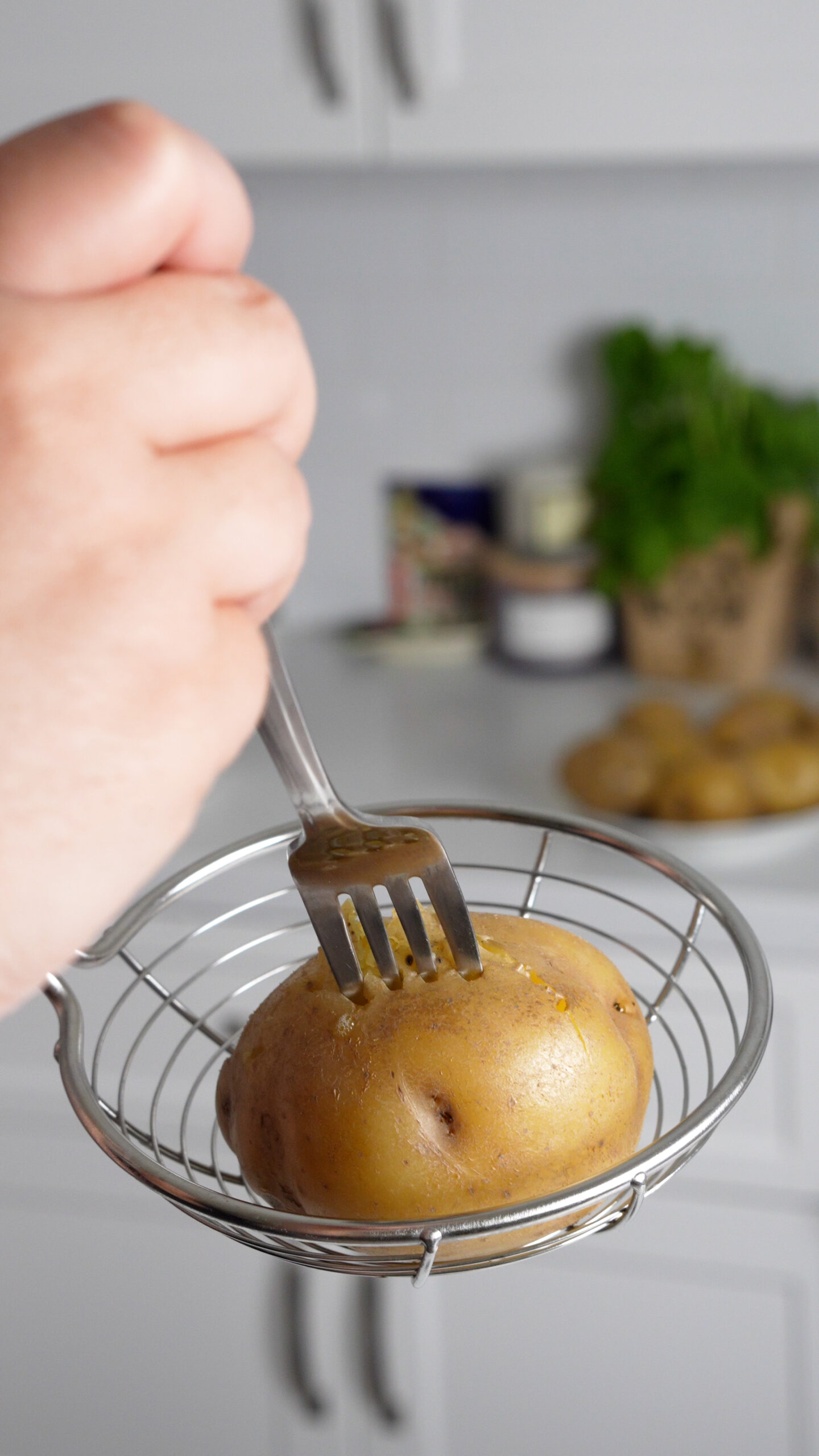 Fork being stuck into a boiled potato