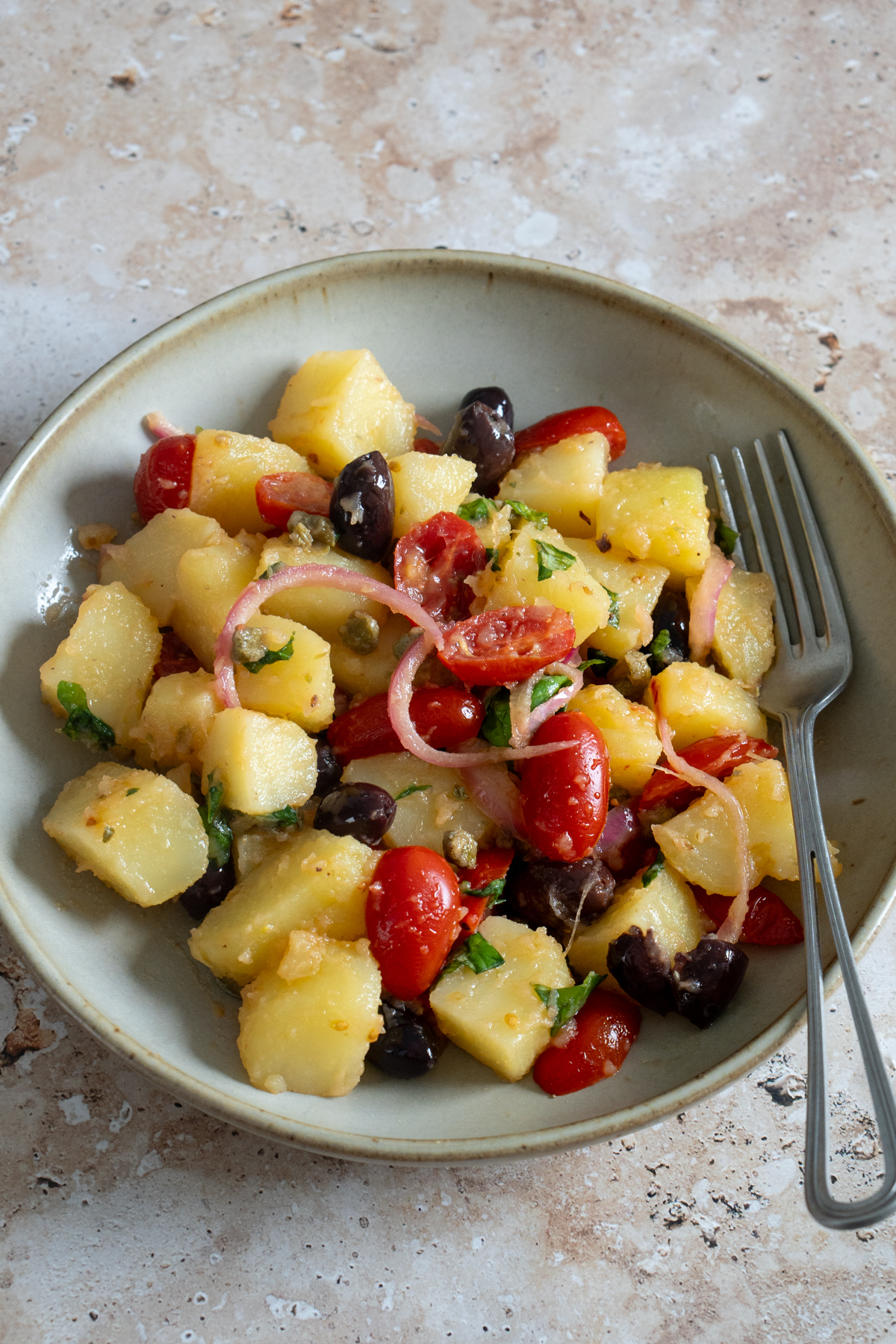 Insalata pantesca in a bowl with a fork to the side