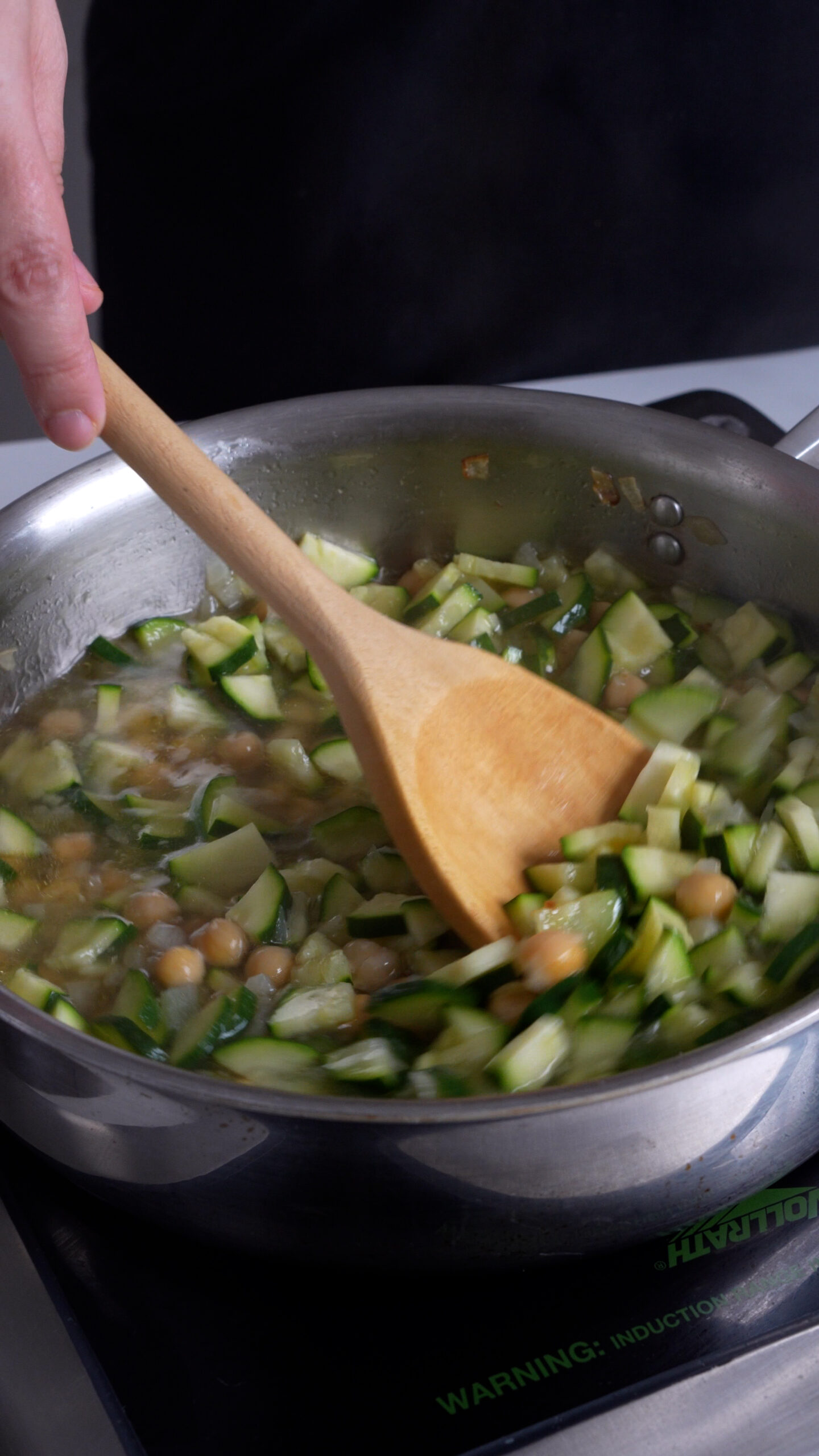 Zucchini and chick peas in a pan with water