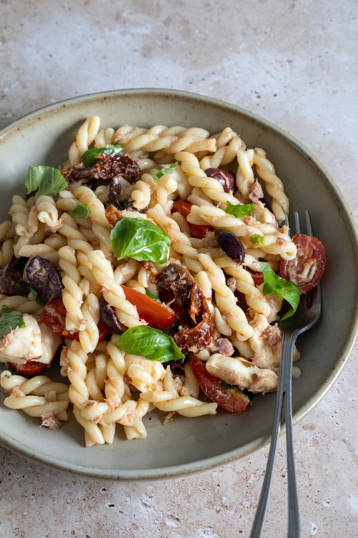 Italian pasta salad in a dish with a fork to the side