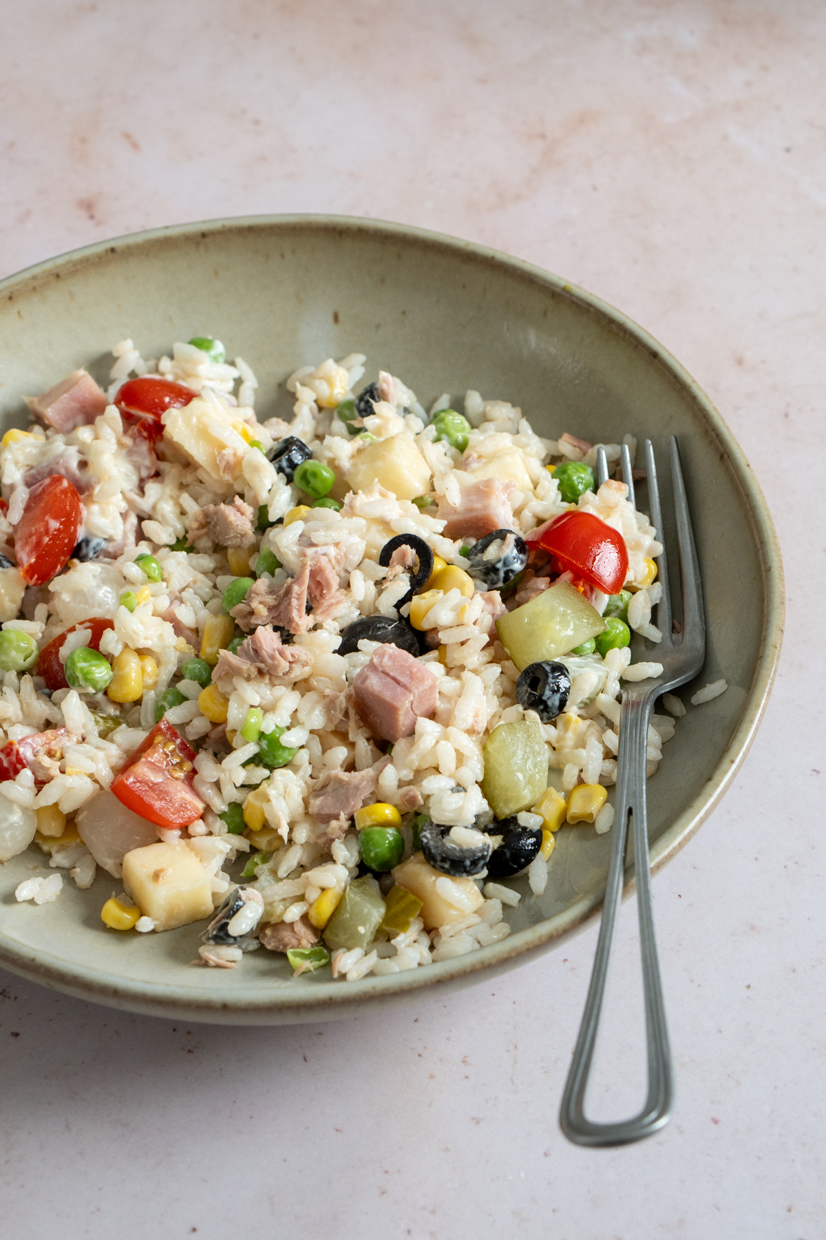 Italian rice salad in a dish with a fork