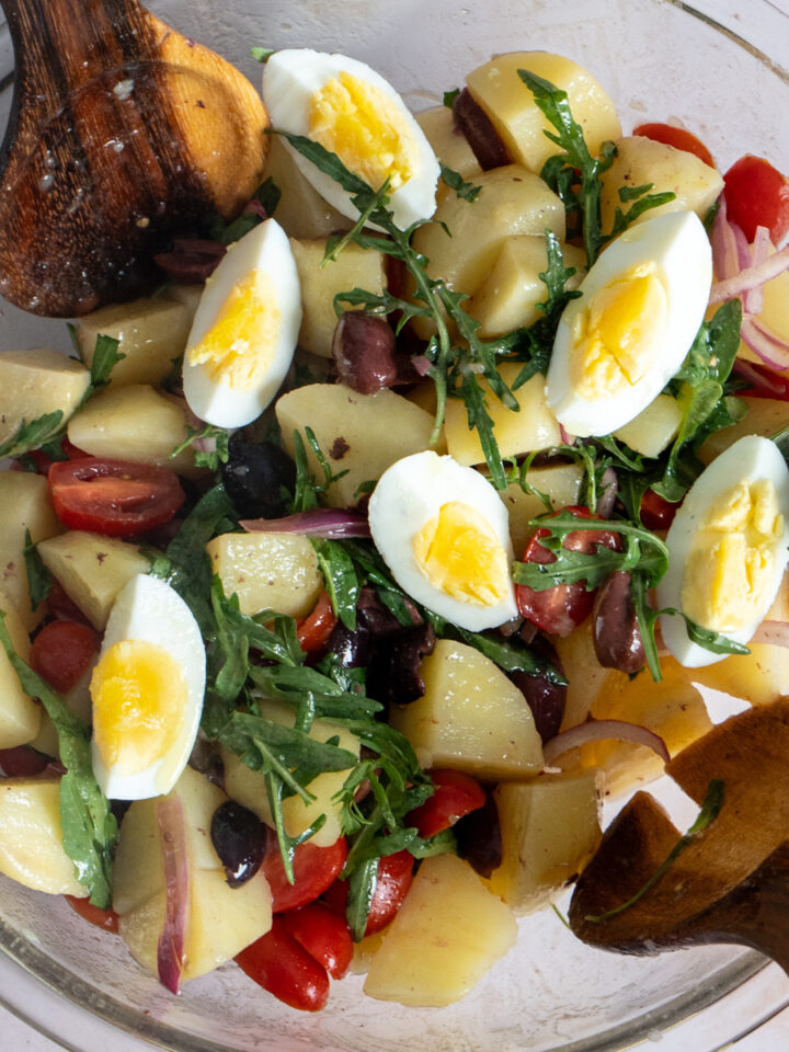 Italian Potato Salad with Arugula topped with hard boiled eggs