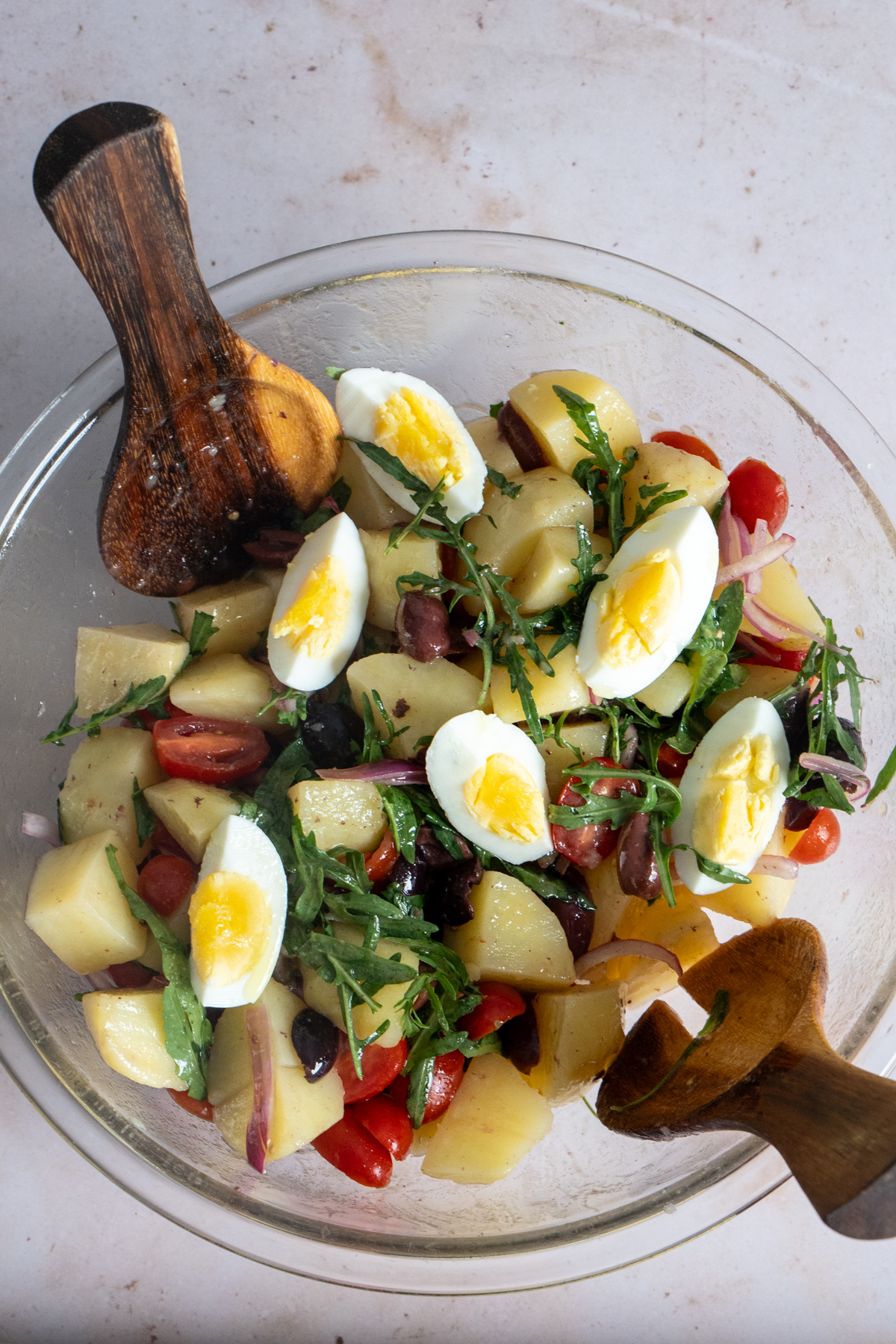 Italian potato salad with arugula in a large glass bowl